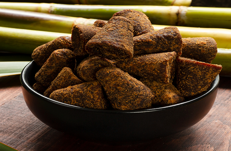 Bulk unrefined cane sugar jaggery blocks in a bowl for wholesale food manufacturing and export supply